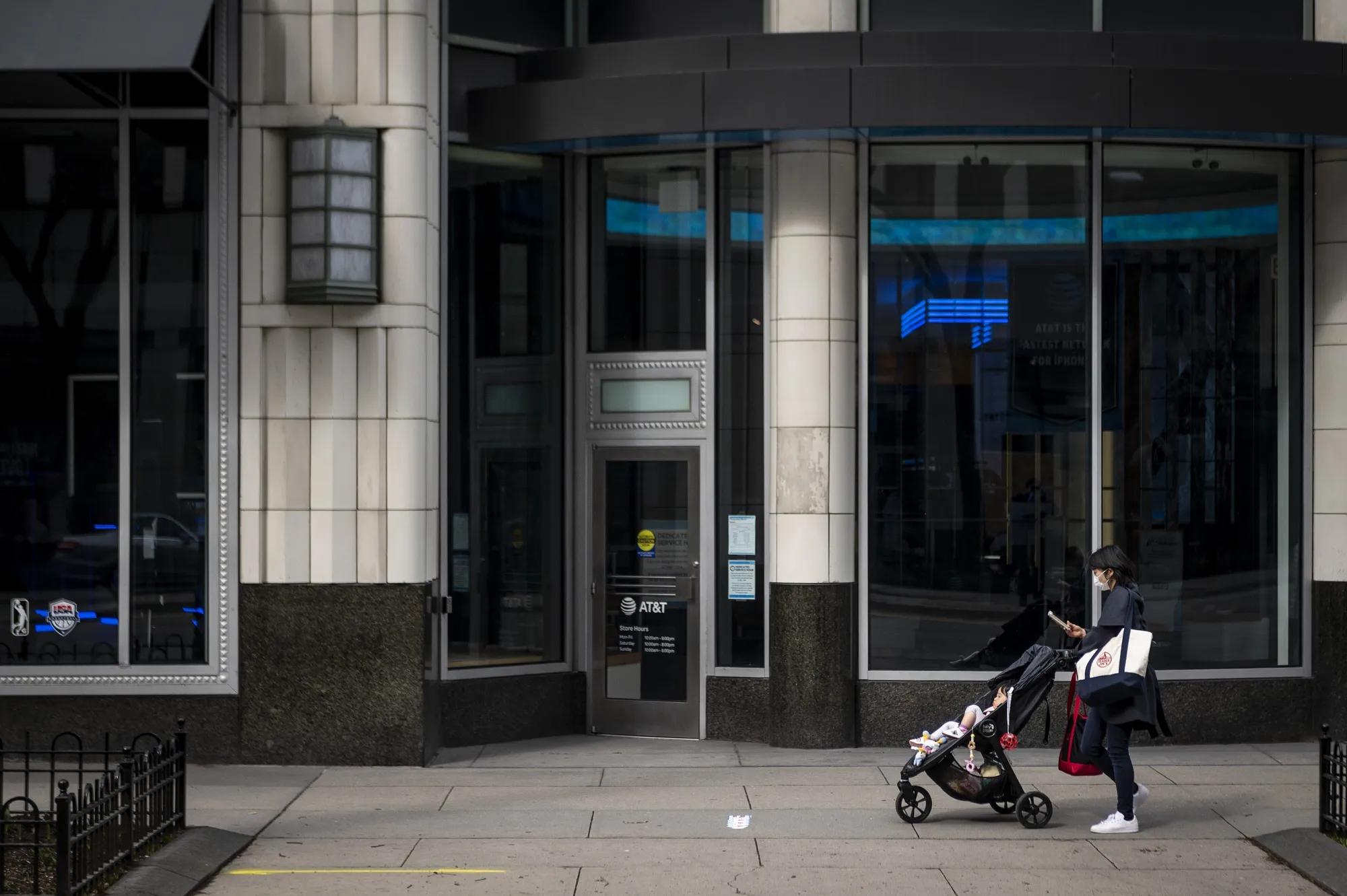 A woman wearing a protective mask pushes a stroller in Chicago on April 3.