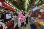 Customers queue to pay for their purchases at a food store in Shanghai. 