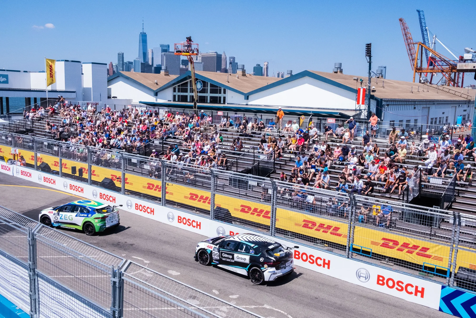 Electric vehicles travel along a racetrack during the ABB FIA Formula E Championship in the Brooklyn borough of New York, U.S.