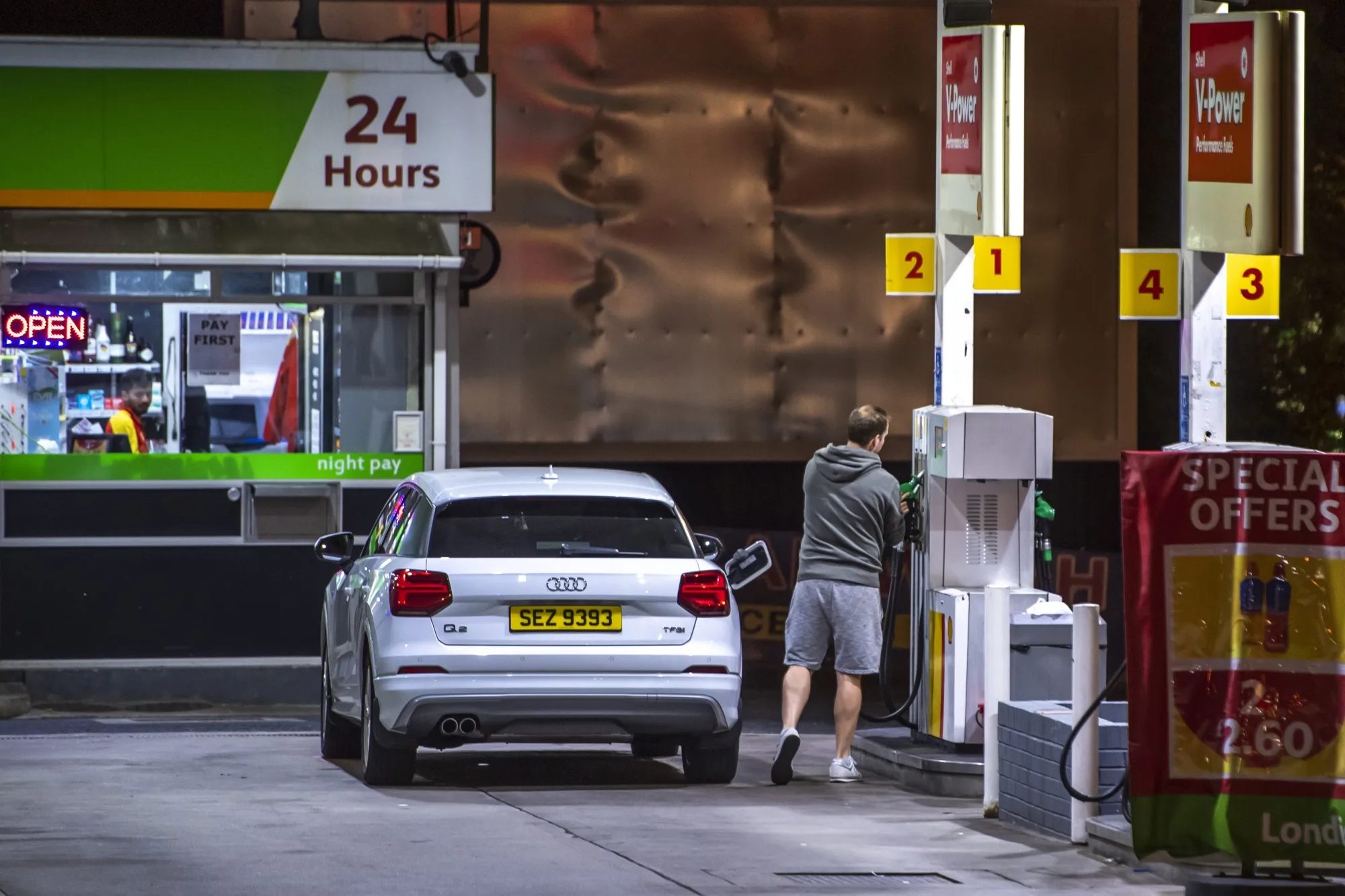 A customer uses a fuel pump at a gas station near Manchester, UK, on Saturday, June 11, 2022.