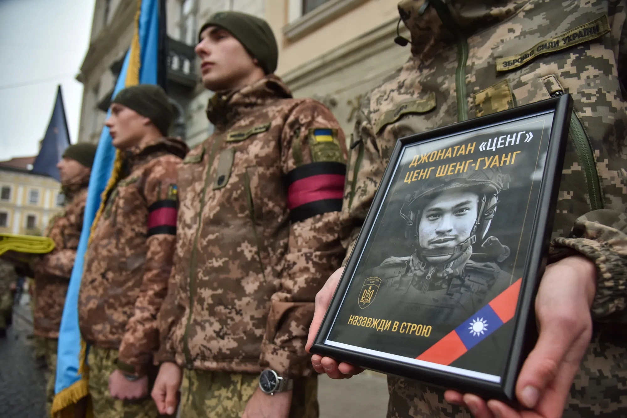A soldier holds a portrait of Jonathan Tseng, a Taiwanese solder who&nbsp;volunteered to fight for Ukraine against Russia, at his memorial service&nbsp;in Lviv, Ukraine, in November&nbsp;2022.