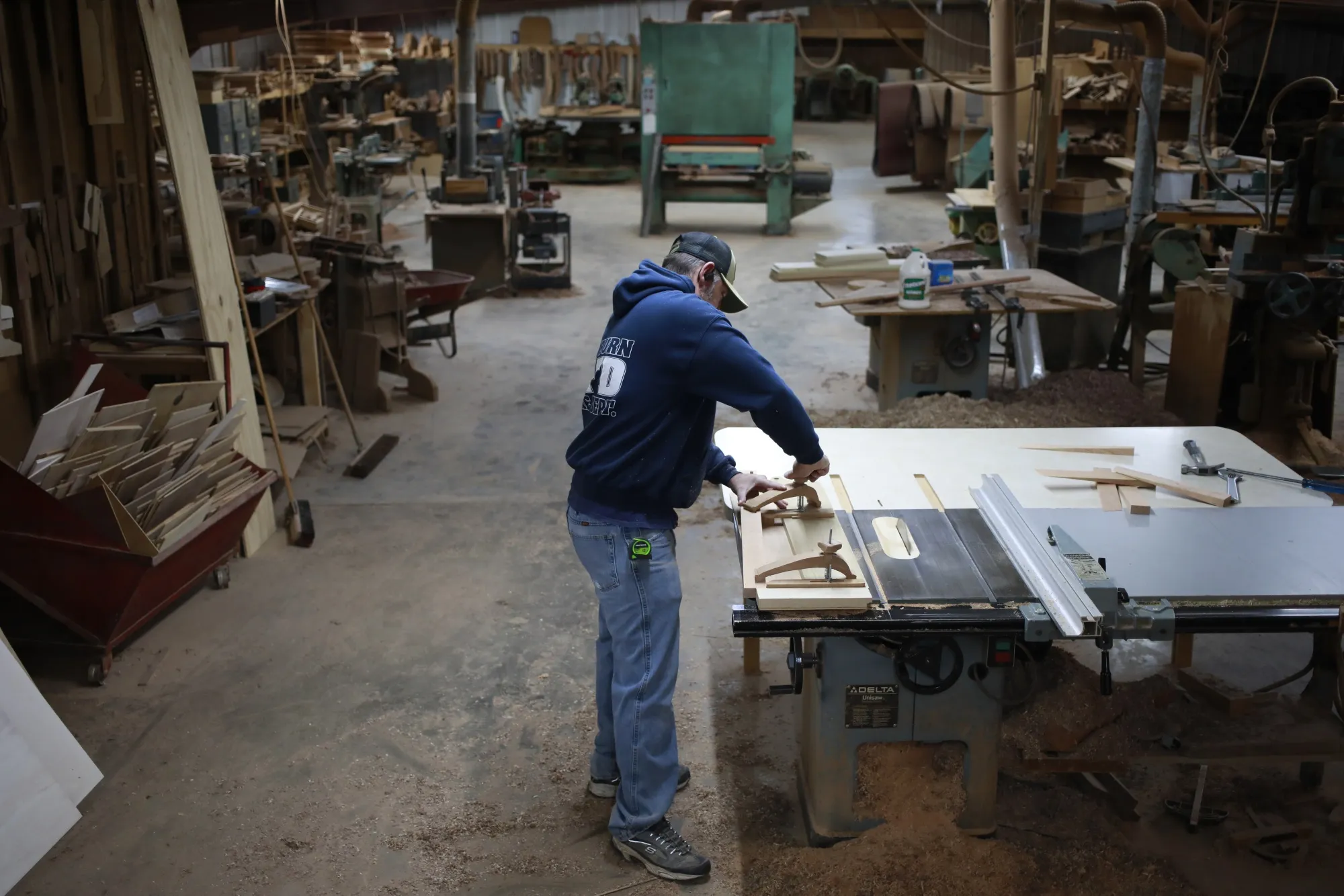 A worker assembles furniture at a wood shop in Auburn, Kentucky.