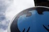 A Barclays logo sits on a sign outside a Barclays Plc bank branch in London, U.K., on Wednesday, May 7, 2014. Barclays will eliminate 14,000 jobs across the firm this year, up from the 12,000 cuts it announced in February, the lender said in a statement today.