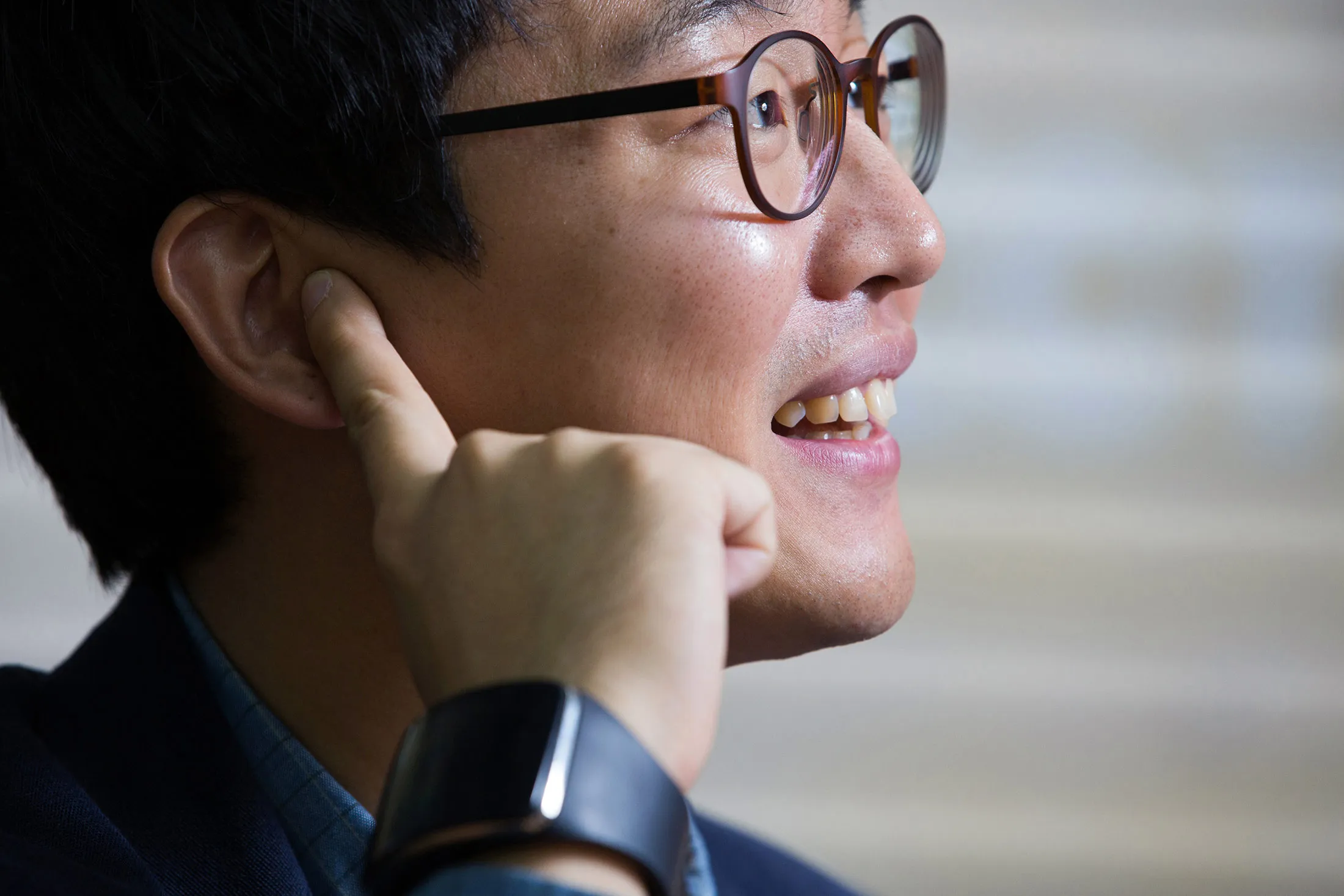 Choi Hyun Chul, chief executive officer of Innomdle Lab, poses for a photograph while wearing the prototype of the TipTalk device with his finger to his ear in Seoul, South Korea, on Oct. 23. Choi, a Samsung Electronics Co. engineer, developed a wristband that keeps eavesdroppers from listening to smartphone conversations.

