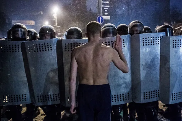 A protester confronts the police during a clash in Kiev on Jan. 22