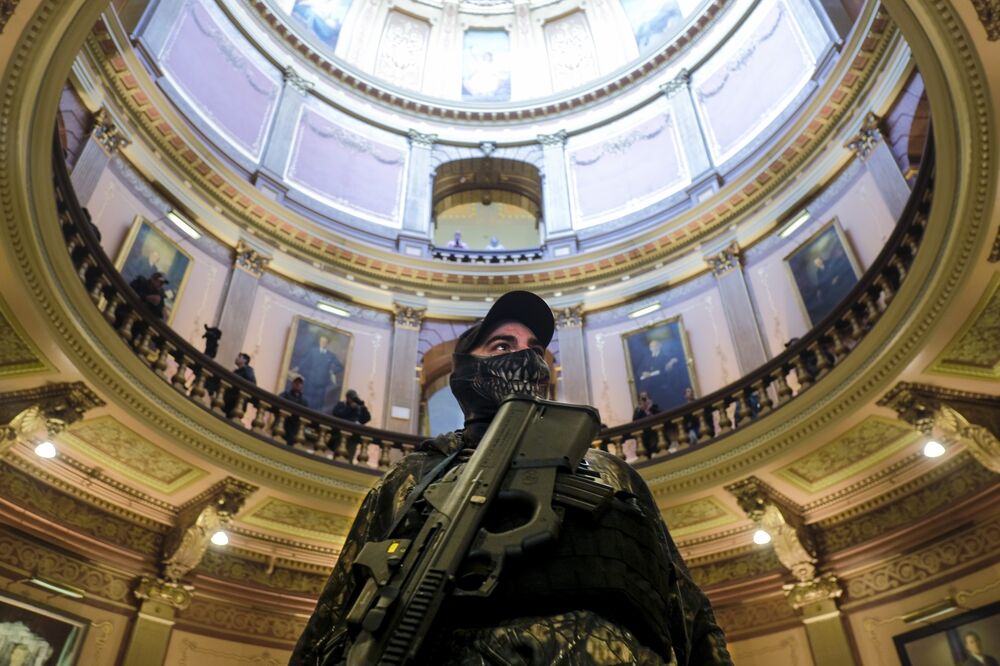 An armed protester stands in the Michigan Capitol Building in Lansing, on April 30.