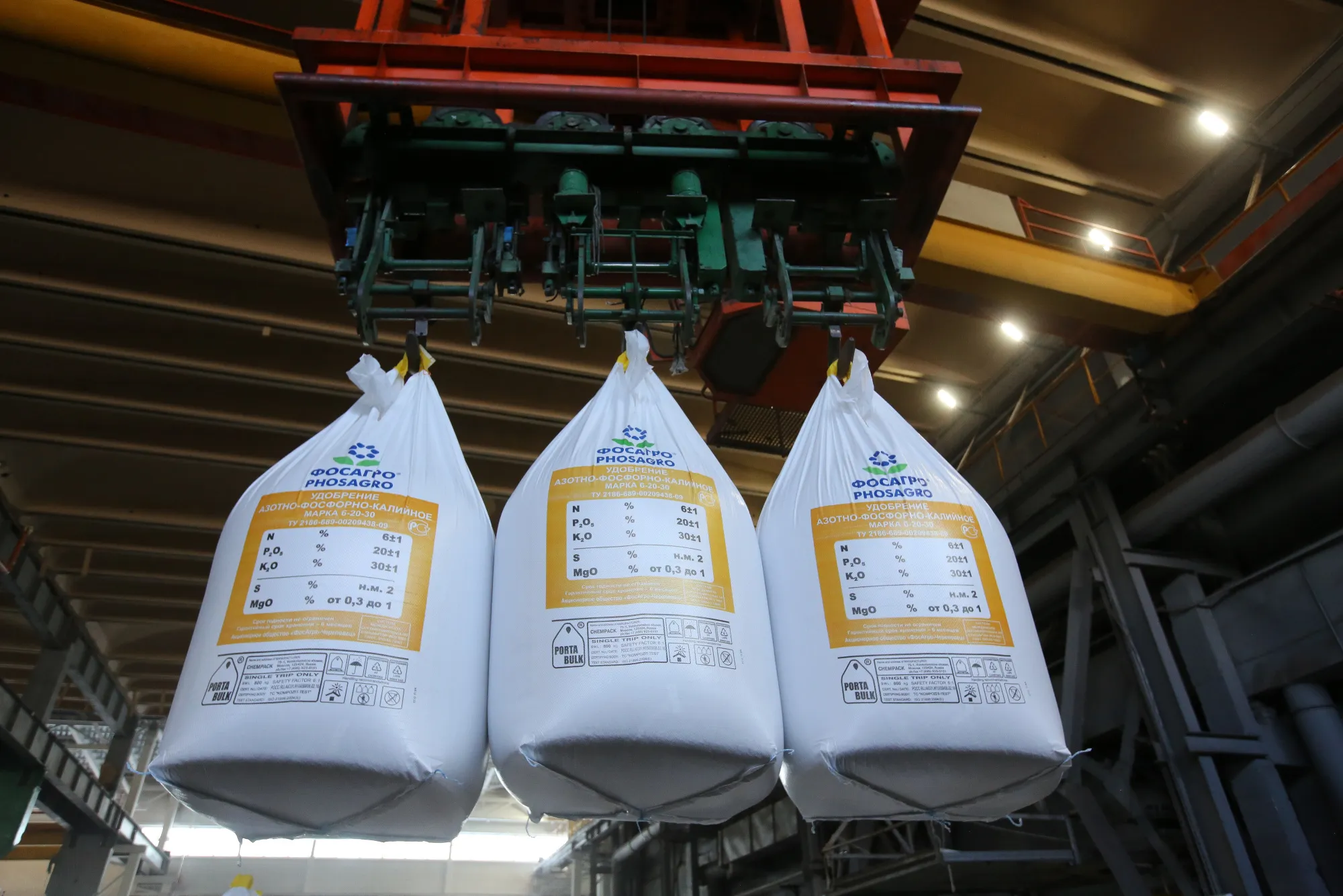 Bags of plant fertilizer are moved by a mechanical hoist at a fertilizer plant in Cherepovets, Russia.