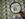 A magnifying glass is held over a 50 subject one dollar note sheet