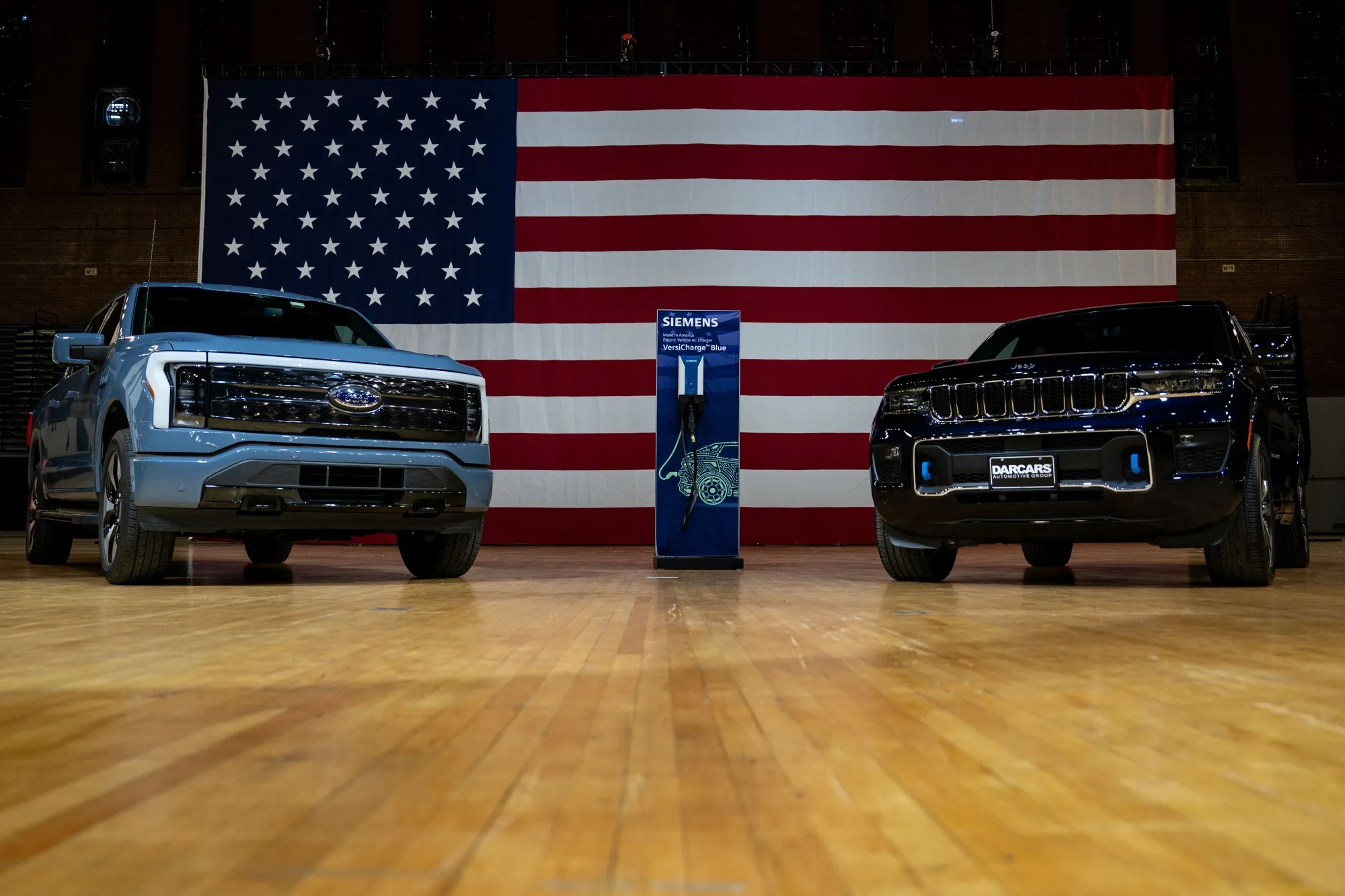 A Ford F-150 Lightning and Jeep Grand Cherokee 4xe at&nbsp;the DC Armory in Washington.