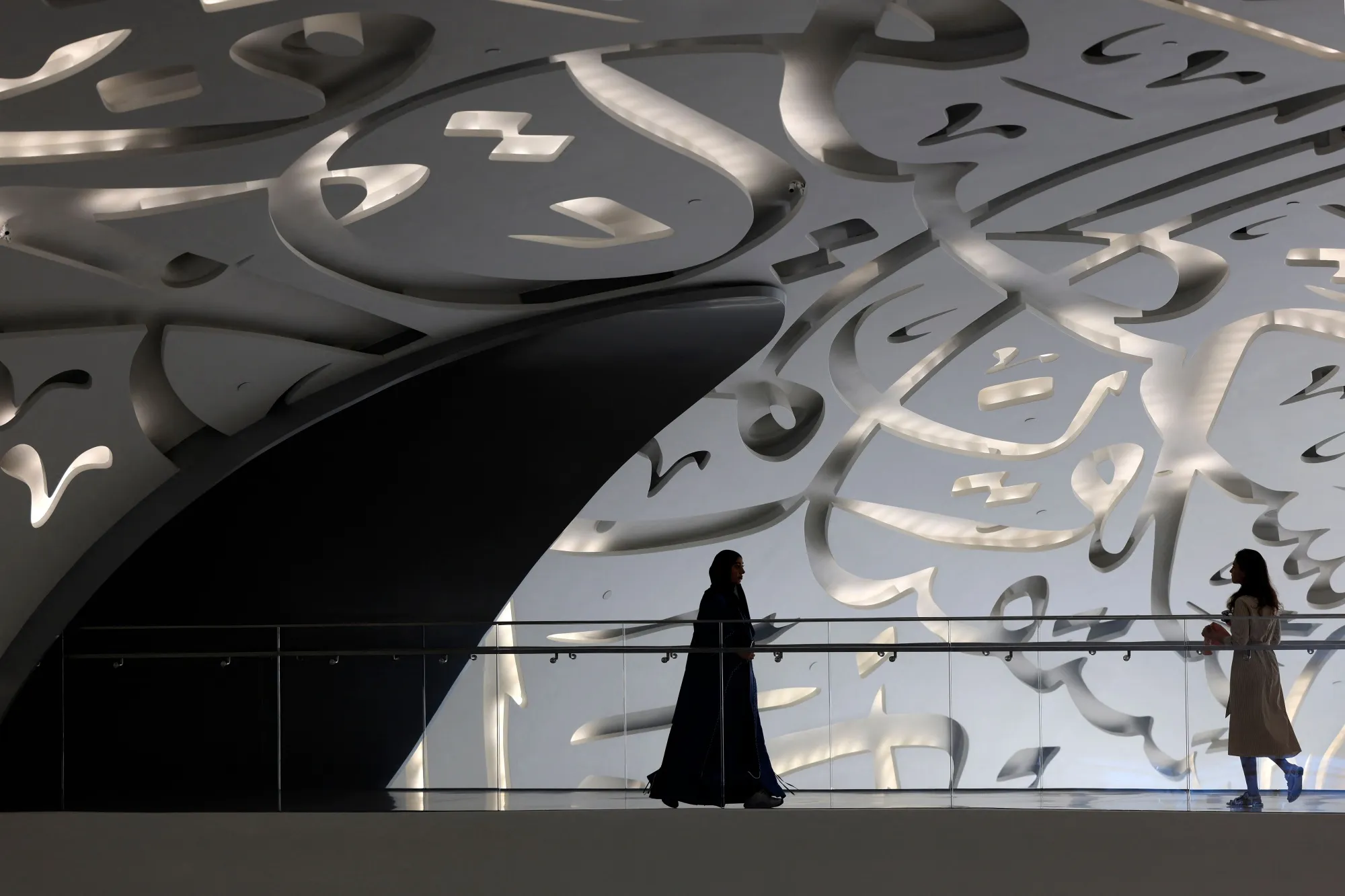 Women walks through the Museum of the Future in Dubai during the Artificial Intelligence Forum held on October 11, 2023.
