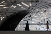 Women walks through the Museum of the Future in Dubai during the Artificial Intelligence Forum held on October 11, 2023.