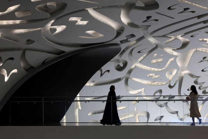 Women walks through the Museum of the Future in Dubai during the Artificial Intelligence Forum held on October 11, 2023.
