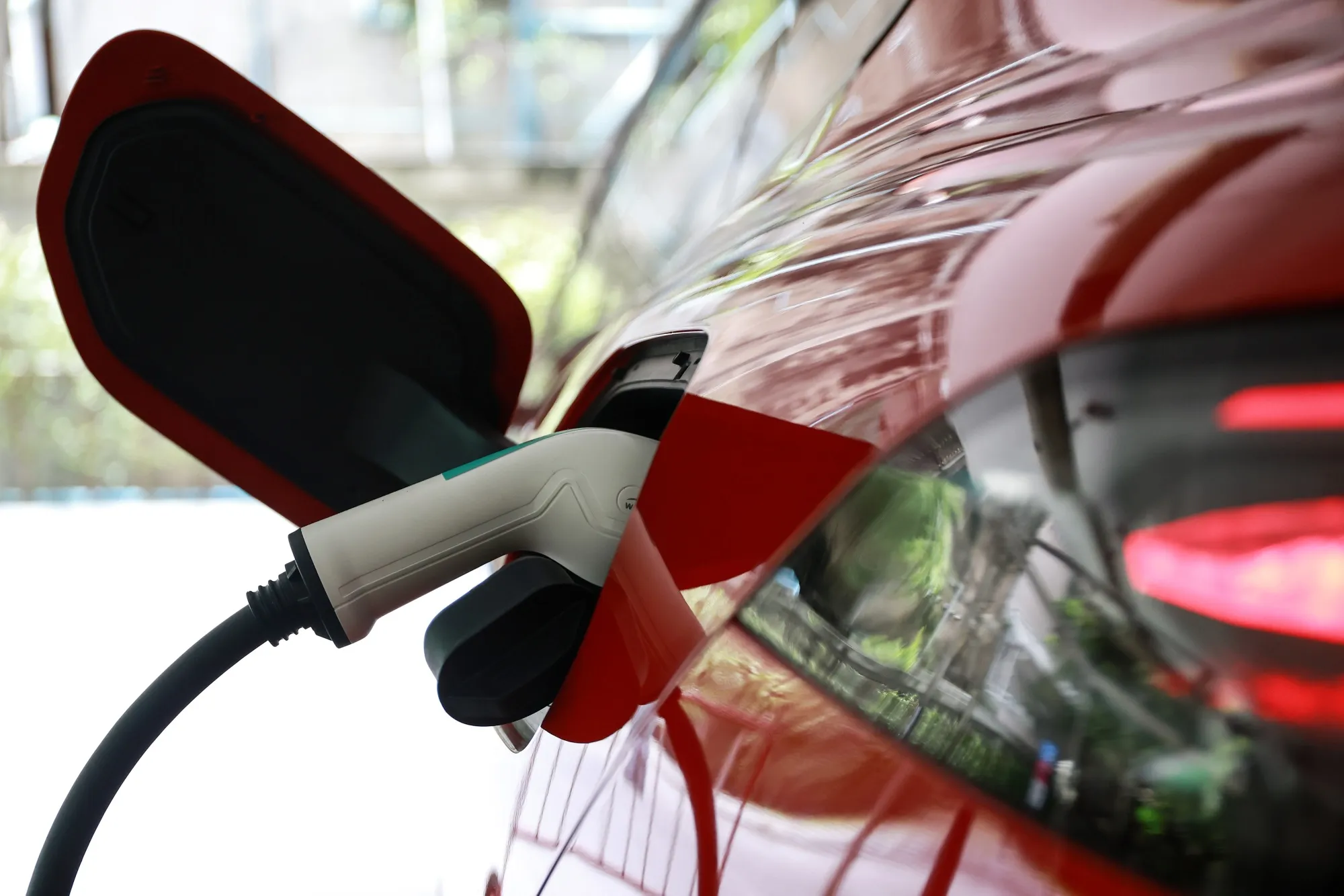 An electric vehicle charger in a vehicle at a charging station.