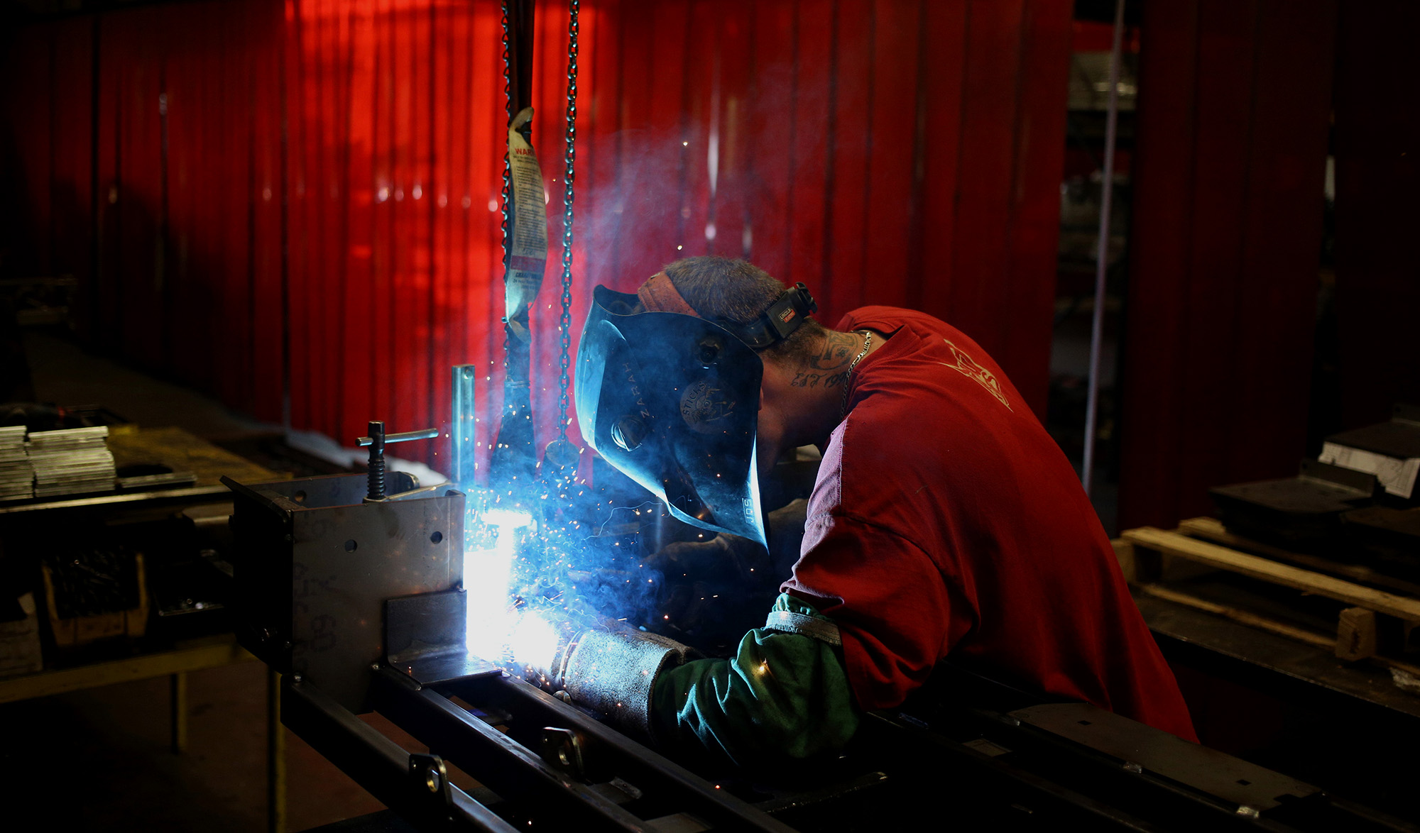 A worker welds a lawnmower frame at a factory in Coatesville, Indiana.