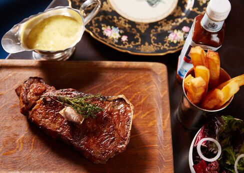 The steaks are served whole, on the bone, with thickly cut French fries and Bearnaise sauce.