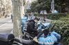 A delivery driver for Ele.me, Alibaba Group Holding Ltd.'s food-delivery platform, wearing a protective mask looks at a smartphone while sitting on a motorcycle in Shanghai, China, on Friday, March 6, 2020. While infections in the rest of the world accelerate, the coronavirus epidemic is showing signs of easing at its center -- China -- with new cases slowing dramatically and recoveries gathering pace. Still, doubt remains over whether the government's statistics show the full picture.