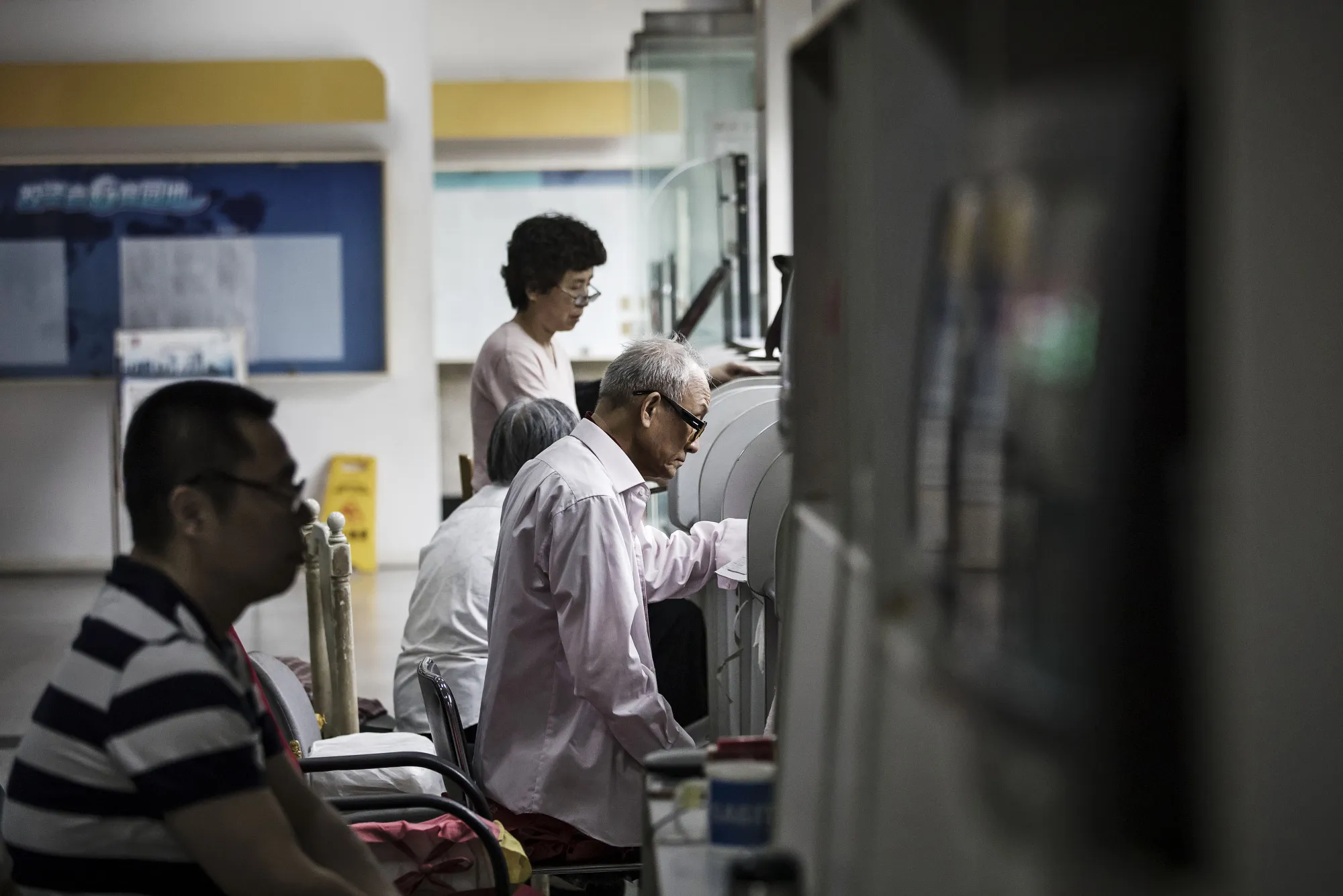 Investors Watch Stock Boards At A Security Firm