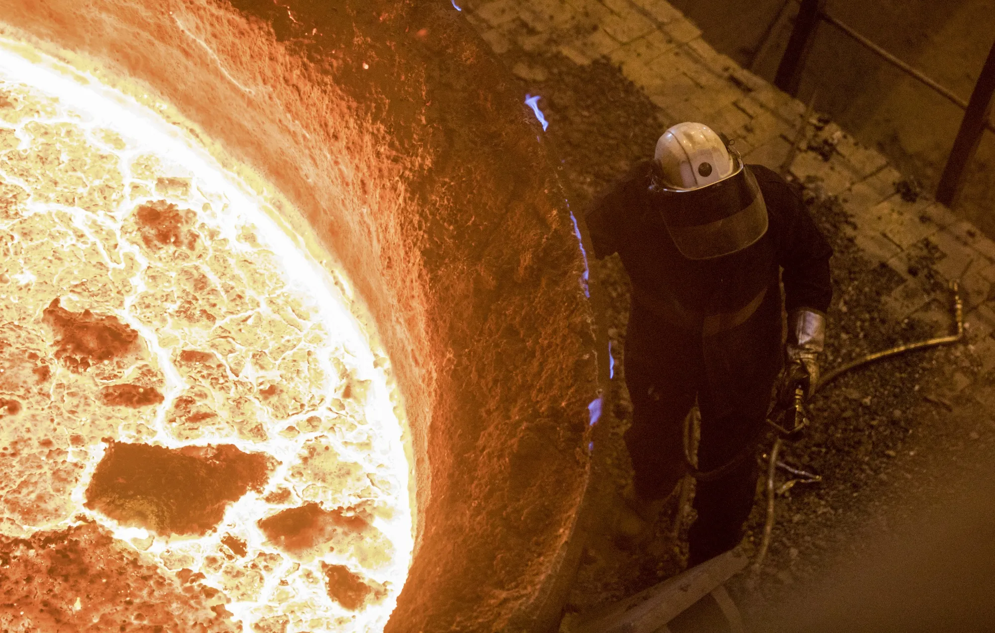 An employee stands beneath a vat of liquid steel at Liberty Steel's Thrybergh mill.