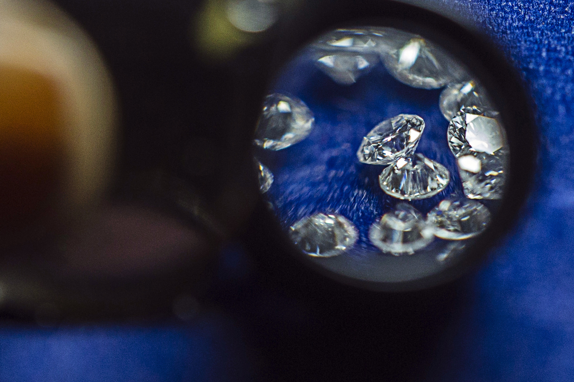 Cut and polished diamonds are seen through a loupe in a&nbsp;factory inTamil Nadu, India.