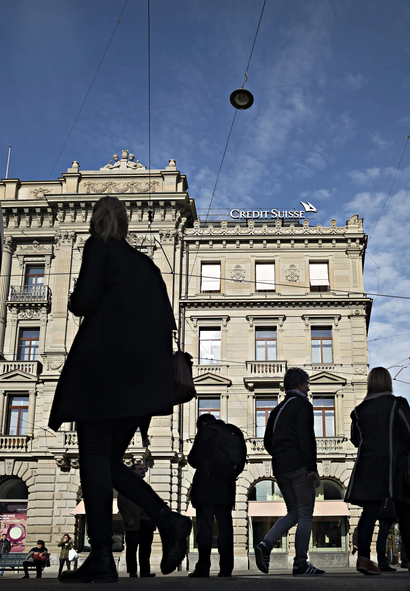 Pedestrians pass by the front of the Credit Suisse Group AG headquarters in Zurich, Switzerland, on Thursday, Nov. 2, 2017.