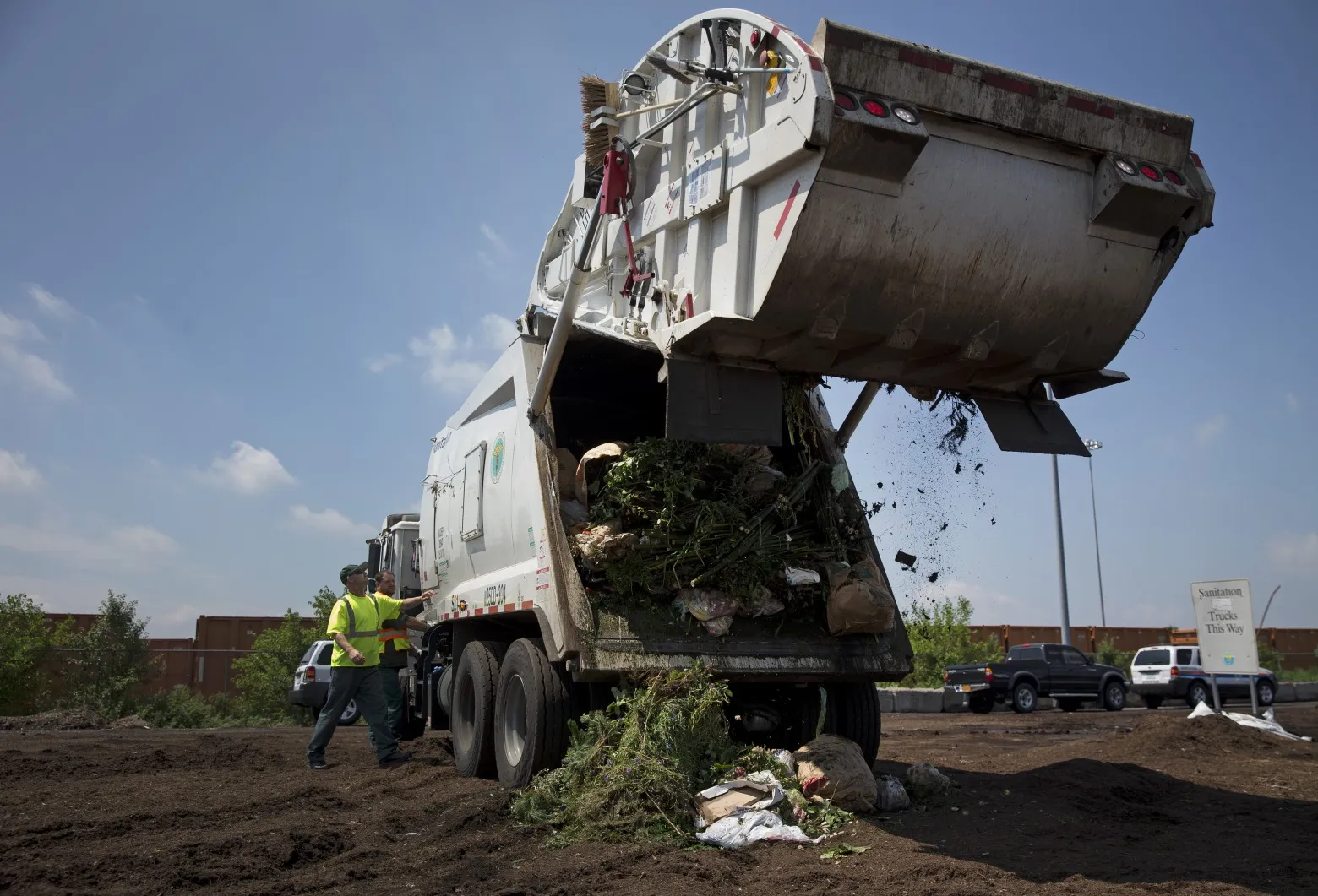 Sanitation Department workers unload a truck in the Staten Island borough of New York.&nbsp;