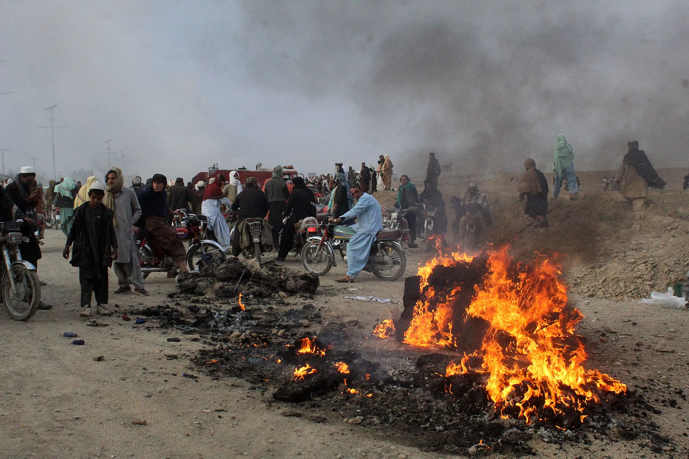 Residents gather after mortars were fired at Pakistan’s border town of Chaman, killing six people on Dec. 11.