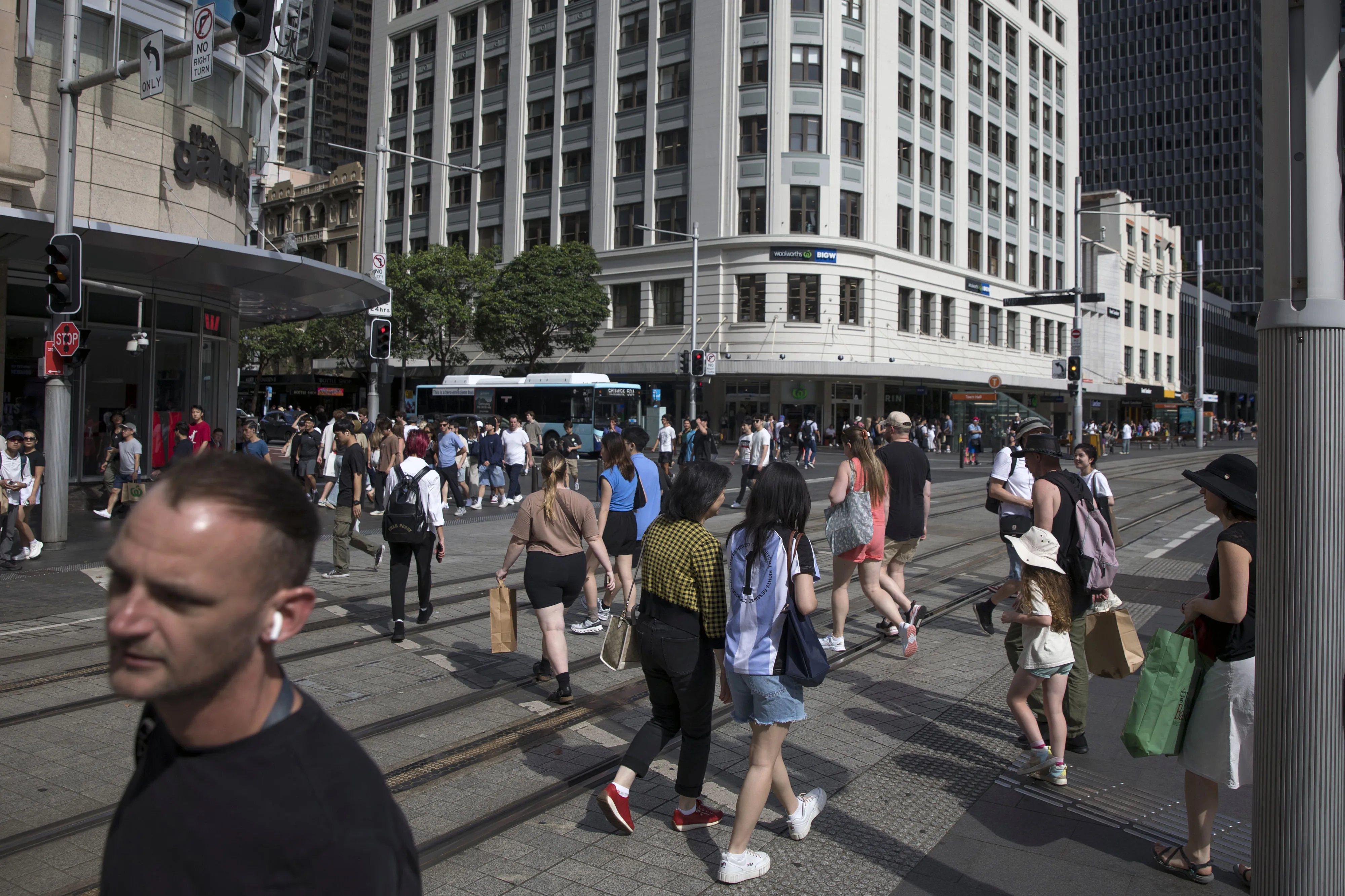 Pedestrians cross an intersection in Sydney.
