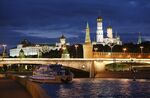 The Kremlin, right, stands illuminated on the banks of the Moscow river in Moscow, Russia.