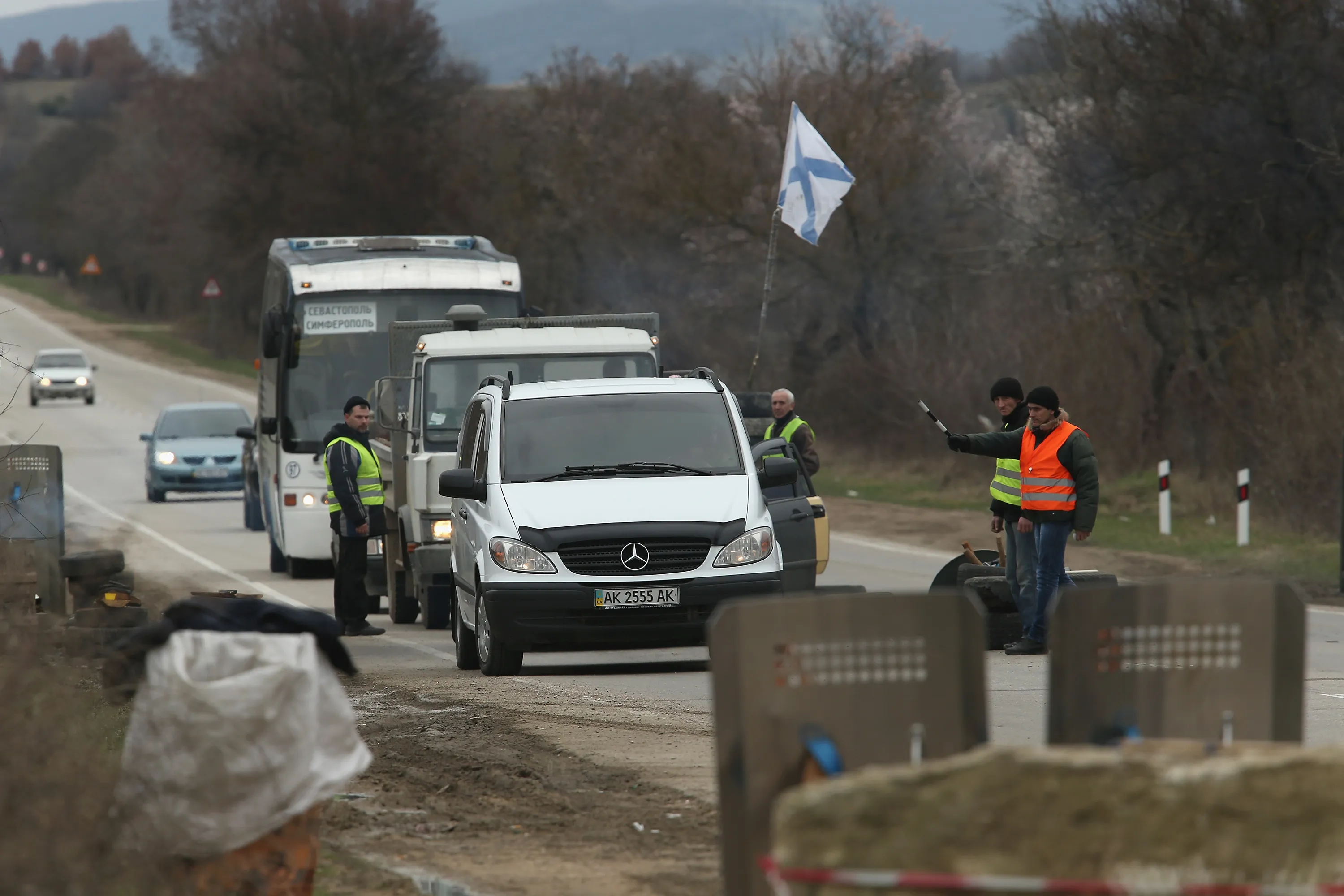 Pro-Russian forces inspect vehicles on the way to Sevastopol in Crimea.&nbsp;Photographer: Sean Gallup/Getty Images