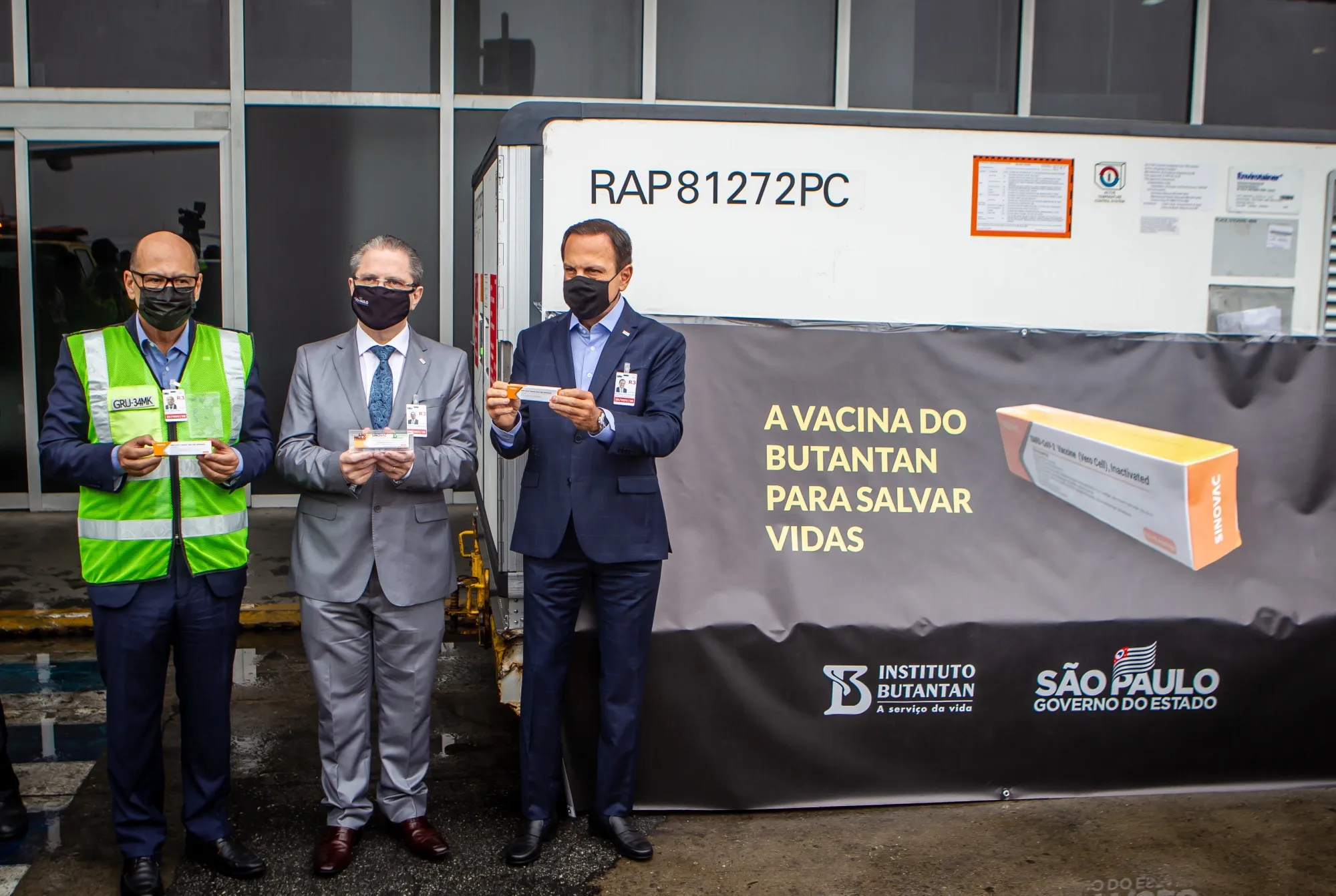 Dimas Tadeu Covas, director of the Butantan Institute, from left, Jean Gorinchteyn, Sao Paulo’s health secretary, and Joao Doria, Sao Paulo’s governor, hold boxes of the Sinovac Biotech Ltd. coronavirus vaccine at Guarulhos International Airport (GRU) in Sao Paulo, Brazil, on Thursday, Nov. 19, 2020.