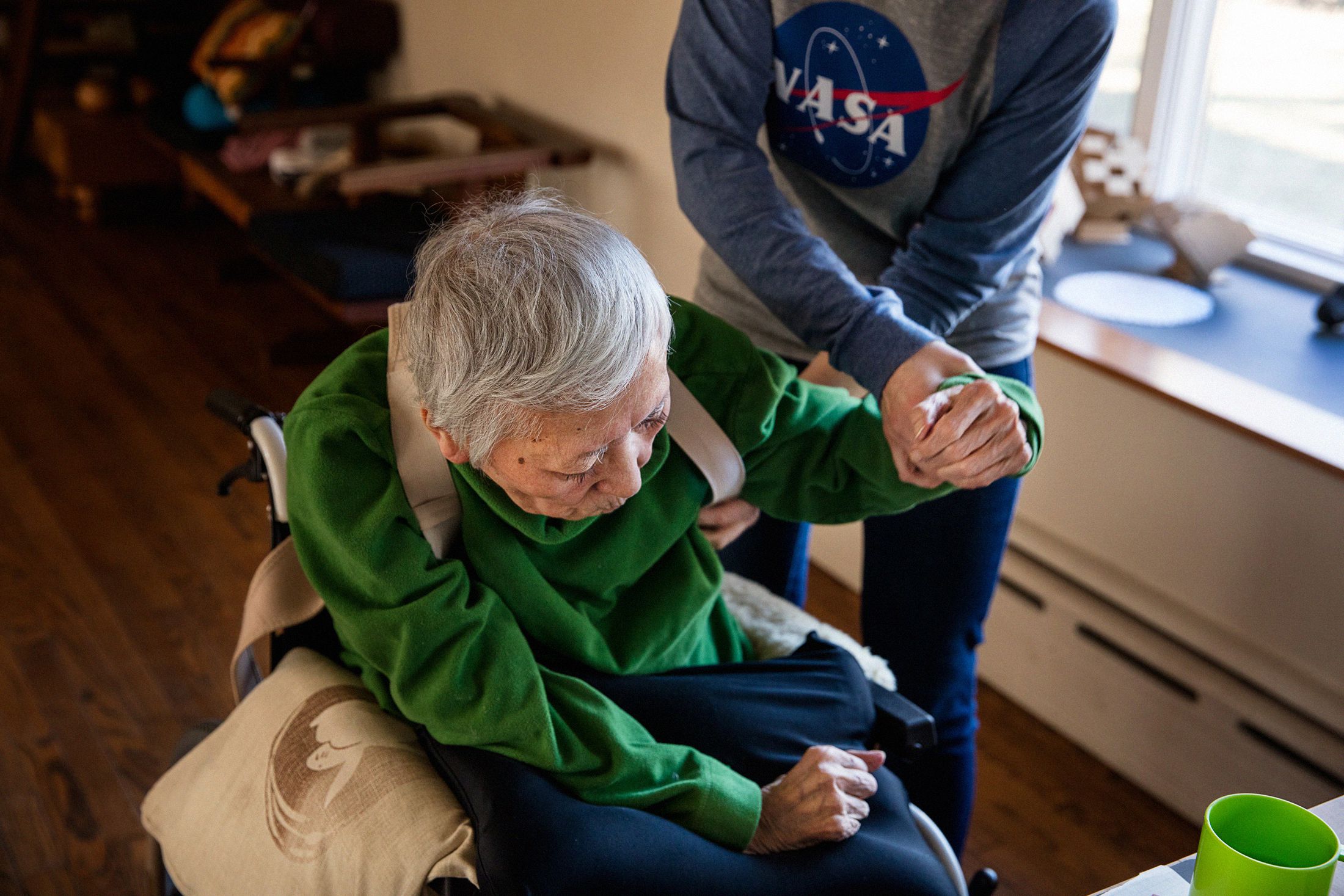 In Greenlawn, N.Y., home health aide Natalia Hubbard helps her client, Noriko Morimoto, who is 82 years old and has Parkinson’s.