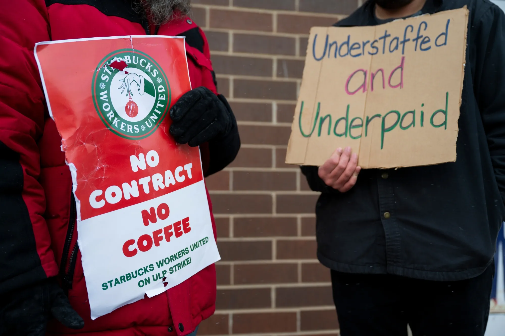 Starbucks Workers United members hold signs while picketing outside a Starbucks store in Chicago in&nbsp;2024.