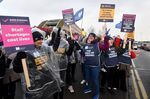Demonstrators hold placards on a picket line during a strike by NHS nursing staff outside Alder Hey Children's Hospital in Liverpool, UK.