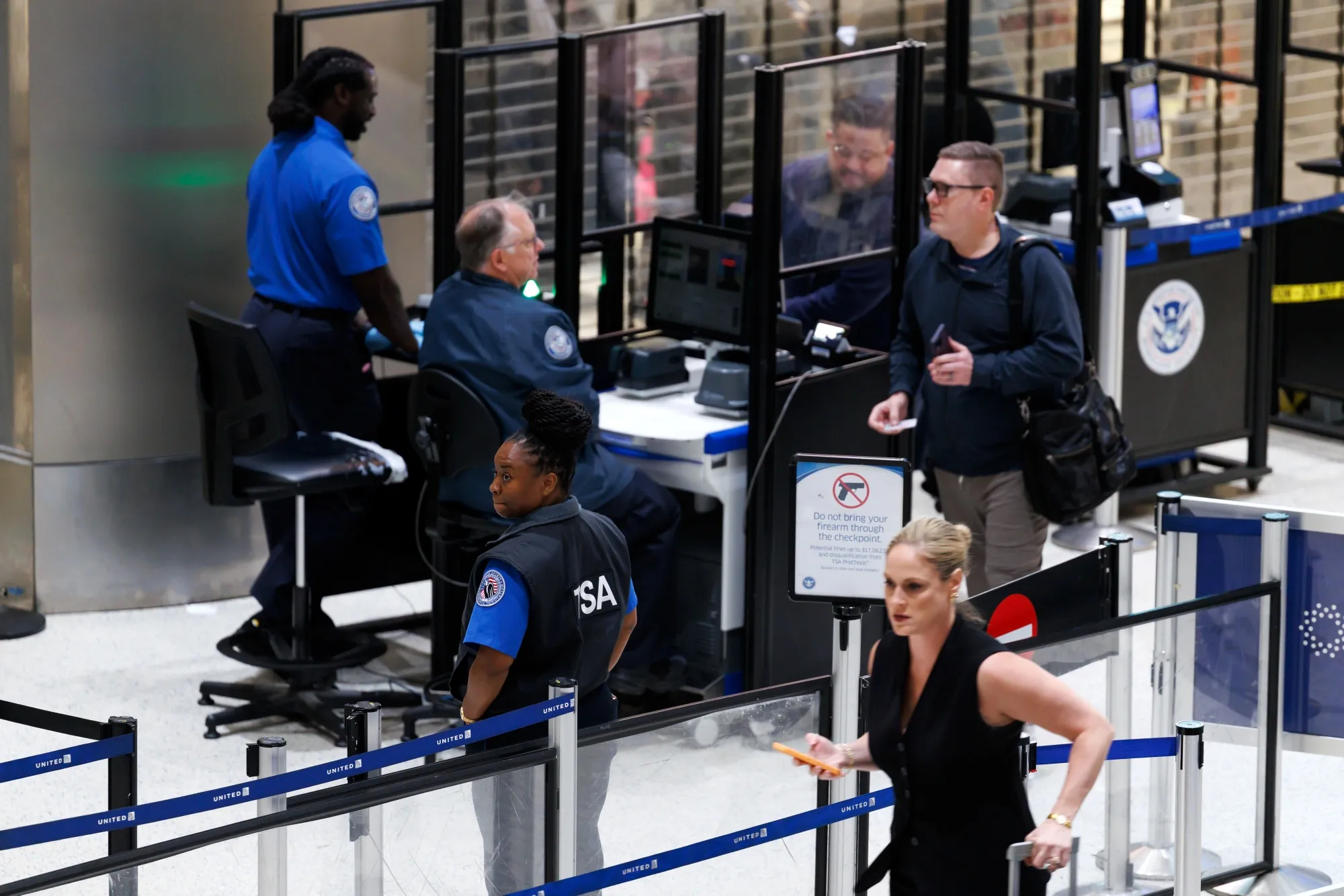 TSA agents assist&nbsp;travelers at George Bush Intercontinental Airport in Houston on March 26.