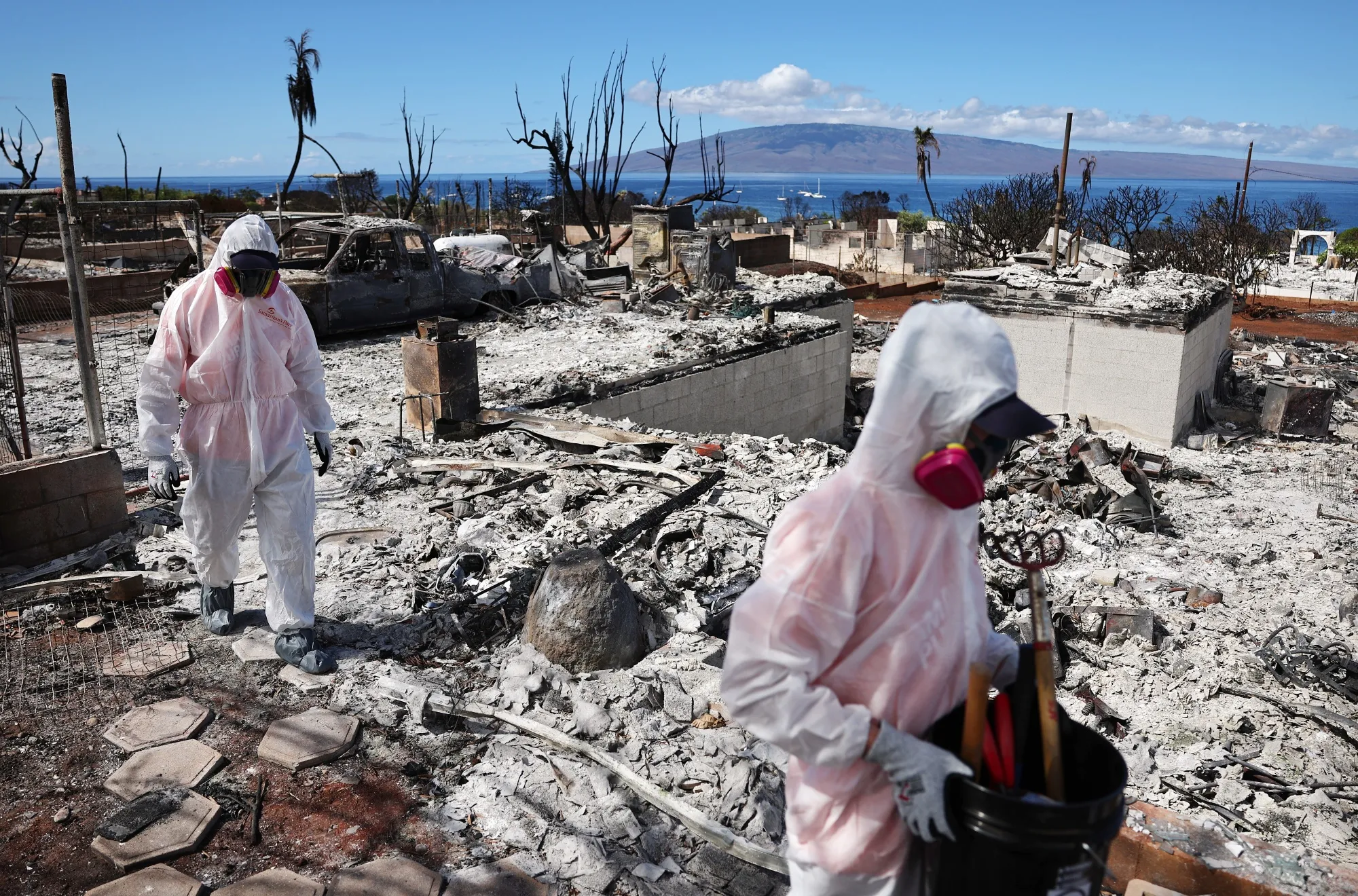 Residents search for items after the wildfire destroyed a home in Lahaina, Hawaii.