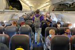 Passengers board a flight from New York.&nbsp;