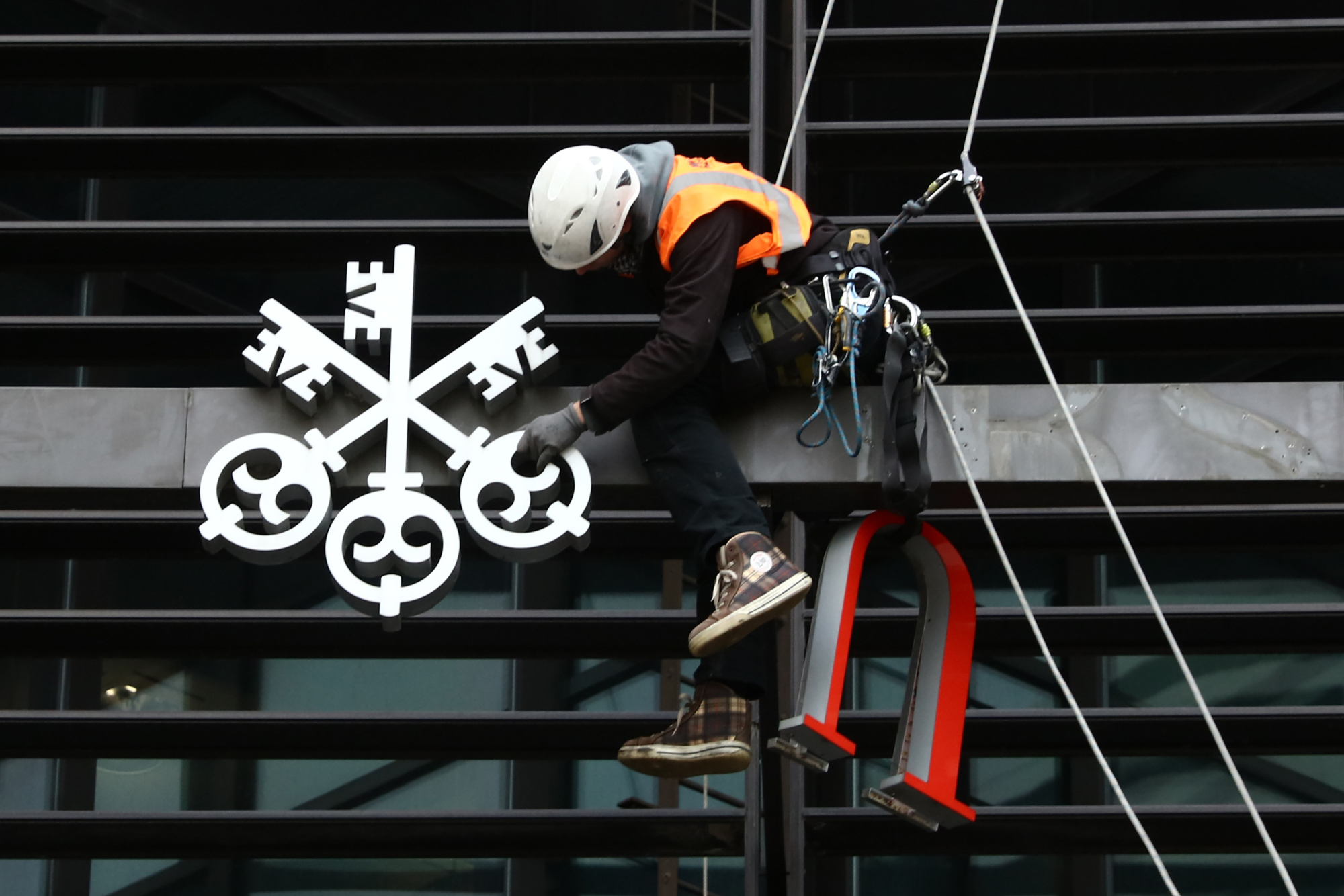 Workers Remove The UBS Group AG Logo From Their Offices At Broadgate Circle
