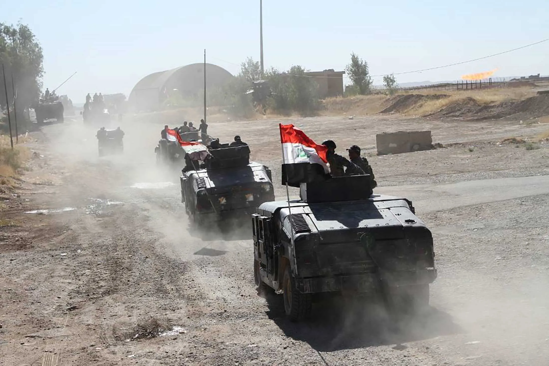 Armored vehicles of Iraqi forces enter the Bai Hassan oil facility after Peshmerga forces withdrew from the area in Kirkuk, Iraq, on Oct. 17, 2017.
