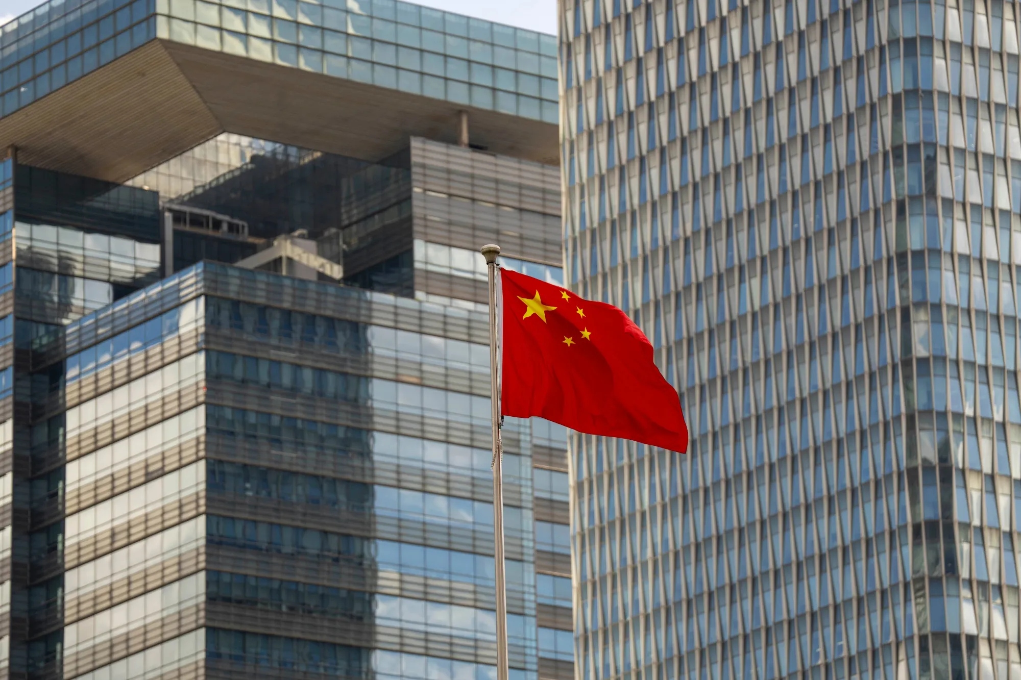 A Chinese flag flies in Pudong’s Lujiazui Financial District in Shanghai, China.