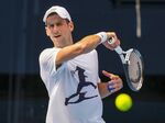 Novak Djokovic practices in the Rod Laver Arena ahead of the Australian Open in Melbourne, on Jan. 11. 
