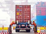 Workers prepare a container at the port in Qingdao, China's eastern Shandong province.