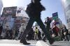 Pedestrians cross an intersection in the Shibuya district of Tokyo, Japan, on Monday, March 18, 2019. Japan's key inflation gauge crept fractionally lower, before a bigger downturn likely later this year that will further slow the Bank of Japan's long journey to its price target.