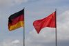 The national flags of Germany and China fly outside the Chancellery in Berlin, Germany, on Friday, May 31, 2019. China said it will establish a list of so-called unreliable" entities it says damage the interests of domestic companies, a sweeping order that could potentially affect thousands of foreign firms as tensions escalateafter the U.S. blacklisted Huawei Technologies Co.