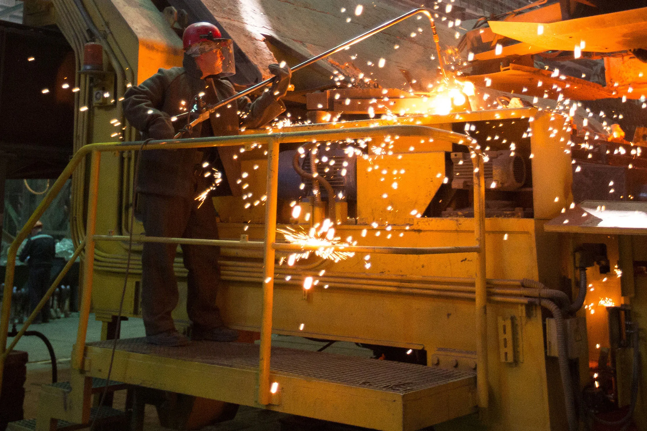 Workers operate an electric arc furnace in the steel smelting shop in Stary Oskol, Russia.