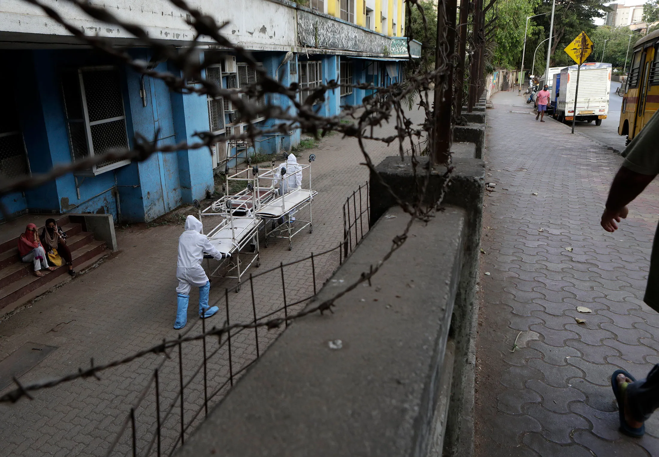 Hospital staff&nbsp;carry empty stretchers from a morgue towards a hospital in Mumbai, India on&nbsp;May 29.