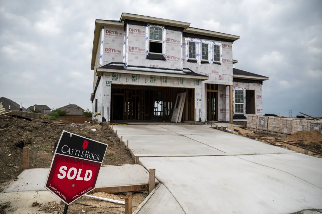 A "Sold" sign sits outside a home under construction in the CastleRock Communities Sunfield residential development in Buda, Texas, U.S., on Wednesday, May 15, 2021. Across the U.S., house prices are skyrocketing, bidding wars are the norm and supply is scarcer than ever. Now the market is too hot even for homebuilders.