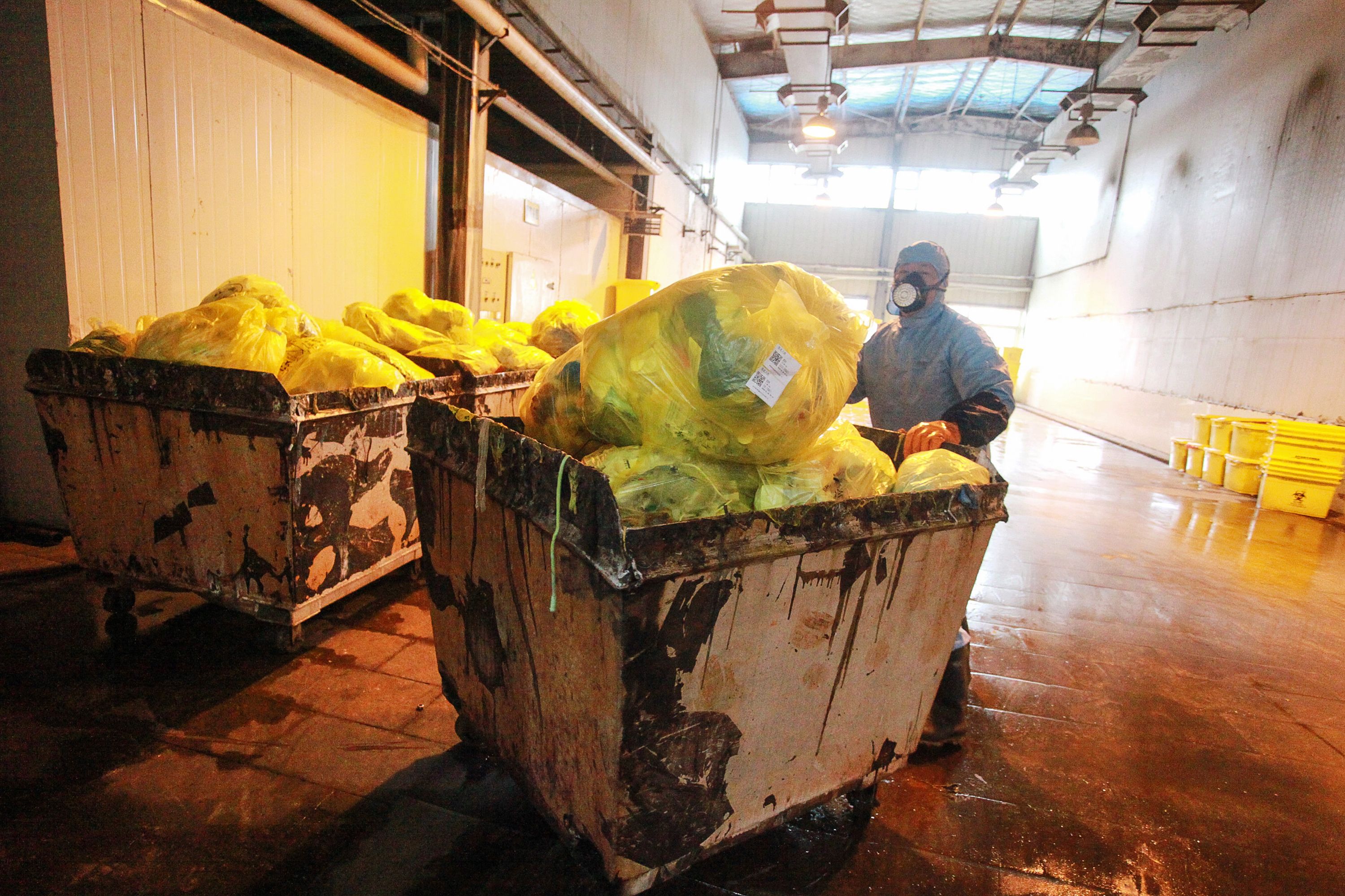 An employee transfers medical waste at a treatment plant in Yangzhou, China in Jan. 2020.