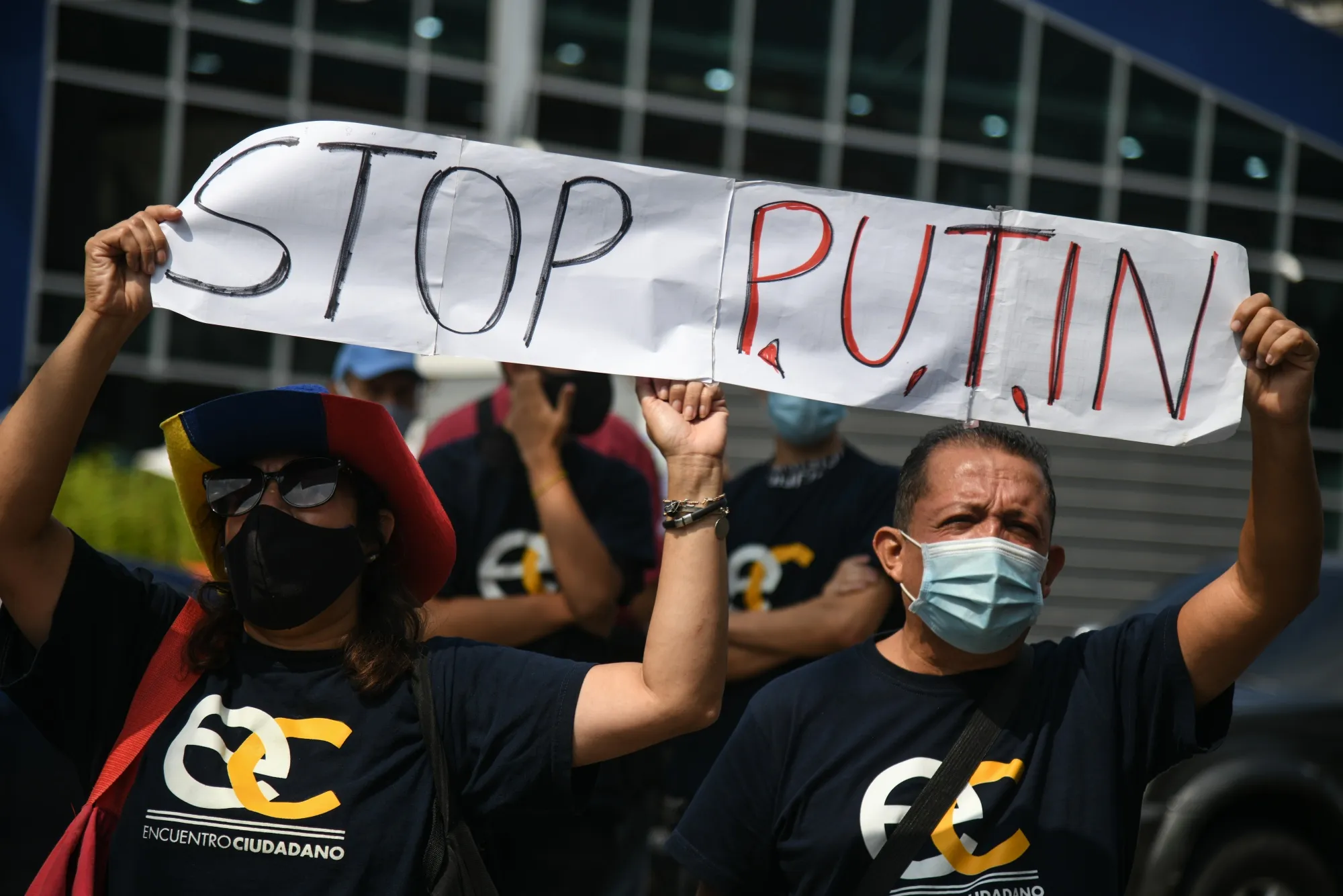 Demonstrators hold a "Stop Putin" banner during a protest against Russia's invasion of Ukraine outside the European Union consulate in Caracas, Venezuela.