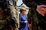 Chancellor Angela Merkel greets members of the NATO unit during a visit in Munster, Germany on May 20.