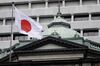 A Japanese national flag flies outside the Bank of Japan (BOJ) headquarters in Tokyo, Japan.